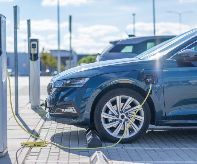 Electric car charging at a station in Europe